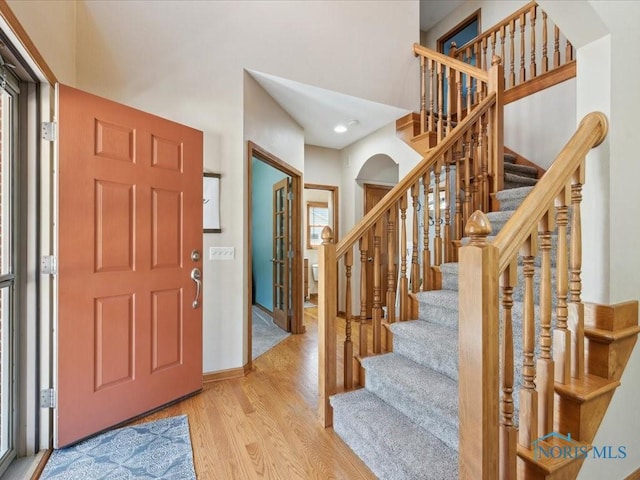 646 Whisperlake Rd, Holland, OH 43528 - entrance foyer featuring wood finished floors, stairs, arched walkways, recessed lighting, and a high ceiling