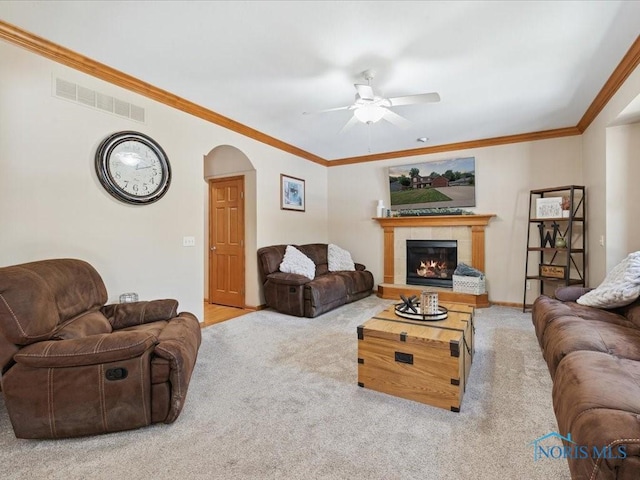 646 Whisperlake Rd, Holland, OH 43528 - carpeted living area featuring ceiling fan, arched walkways, a fireplace, and ornamental molding