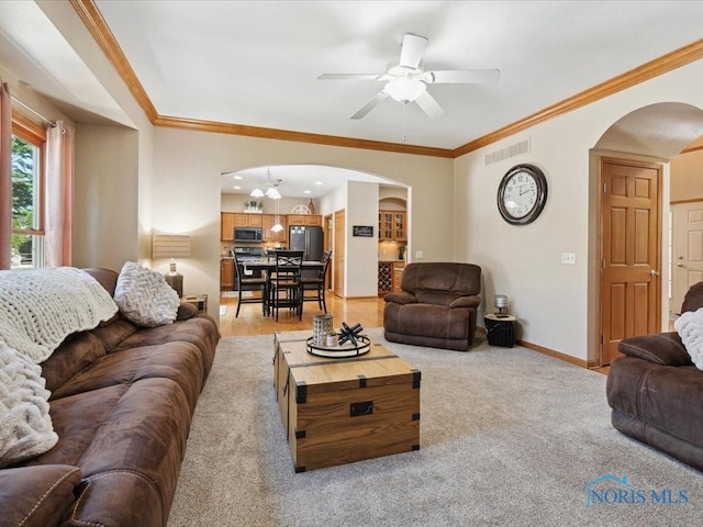 646 Whisperlake Rd, Holland, OH 43528 - living area featuring arched walkways, ceiling fan, ornamental molding, and light carpet