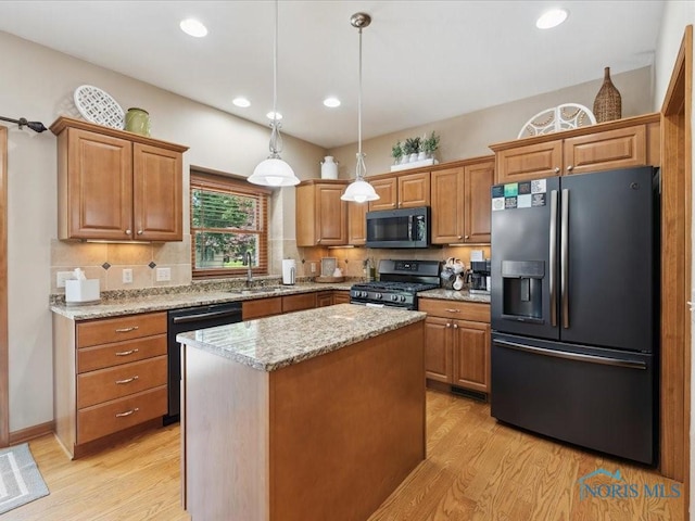 646 Whisperlake Rd, Holland, OH 43528 - kitchen with stainless steel appliances, light wood-style flooring, brown cabinetry, and recessed lighting
