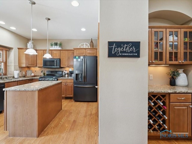 646 Whisperlake Rd, Holland, OH 43528 - kitchen featuring refrigerator with ice dispenser, gas stove, light wood-style flooring, light stone counters, and recessed lighting