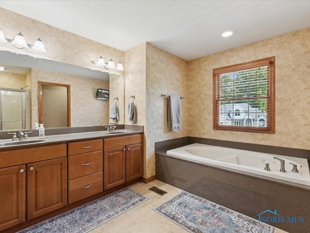 646 Whisperlake Rd, Holland, OH 43528 - full bathroom featuring a garden tub, double vanity, a shower stall, and tile patterned floors