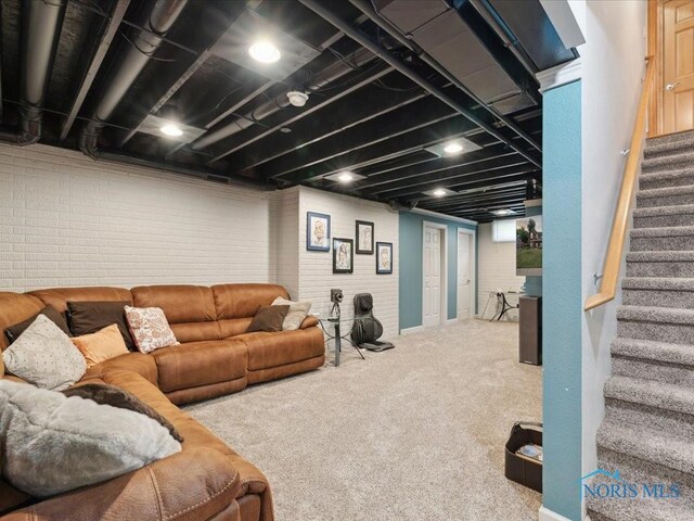 646 Whisperlake Rd, Holland, OH 43528 - carpeted living room featuring stairs and brick wall