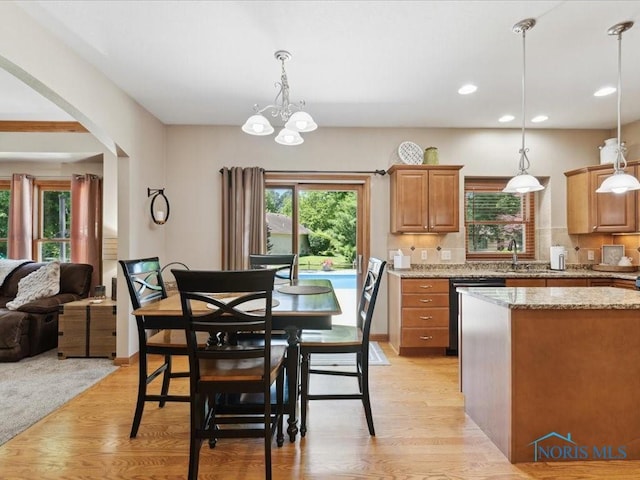 646 Whisperlake Rd, Holland, OH 43528 - kitchen with dishwasher, arched walkways, light wood-type flooring, recessed lighting, and light stone countertops
