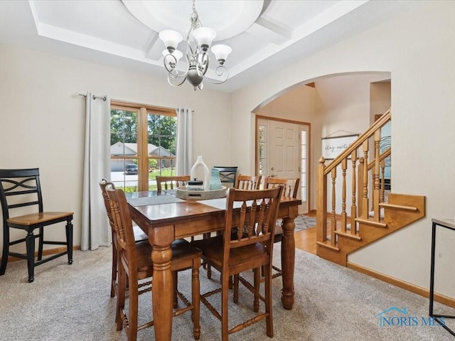 646 Whisperlake Rd, Holland, OH 43528 - dining area with arched walkways, a chandelier, coffered ceiling, light colored carpet, and stairway