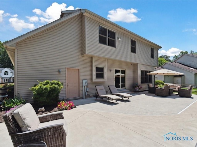 646 Whisperlake Rd, Holland, OH 43528 - rear view of property with an outdoor hangout area and a patio area