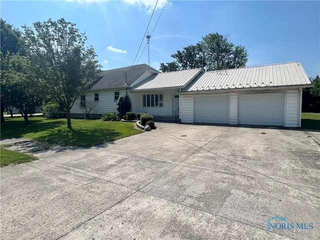 107 N Maple St, Payne, OH 45880 - single story home with a front yard, a garage, driveway, and a metal roof