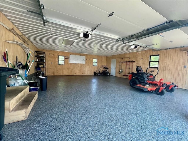 107 N Maple St, Payne, OH 45880 - garage with wood walls and a garage door opener