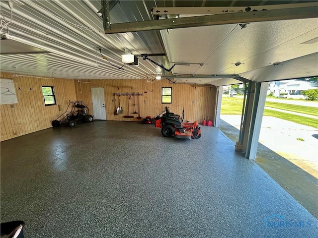 107 N Maple St, Payne, OH 45880 - garage with a garage door opener and wooden walls
