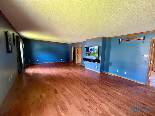 107 N Maple St, Payne, OH 45880 - unfurnished living room featuring a textured ceiling, hardwood / wood-style floors, and crown molding