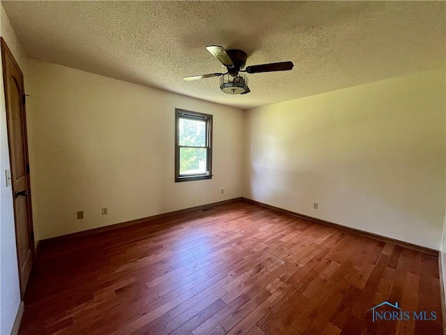 107 N Maple St, Payne, OH 45880 - unfurnished room featuring dark wood-style flooring, a textured ceiling, and ceiling fan