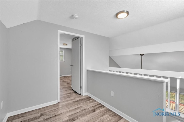 1845 Newport Ave, Toledo, OH 43613 - bonus room featuring wood finished floors, lofted ceiling, and a textured ceiling