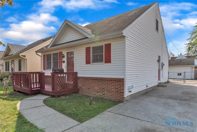 1845 Newport Ave, Toledo, OH 43613 - ranch-style home with a wooden deck, brick siding, and a shingled roof