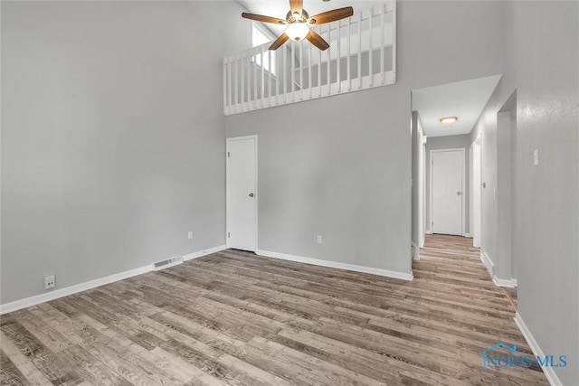 1845 Newport Ave, Toledo, OH 43613 - unfurnished room featuring a high ceiling, a ceiling fan, and wood finished floors