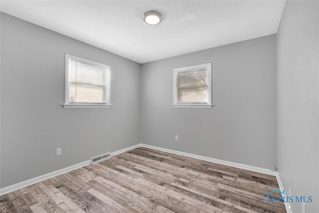 1845 Newport Ave, Toledo, OH 43613 - unfurnished room featuring plenty of natural light and wood finished floors