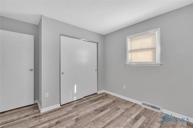 1845 Newport Ave, Toledo, OH 43613 - unfurnished bedroom featuring wood finished floors and a closet