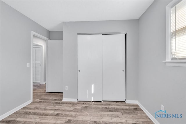 1845 Newport Ave, Toledo, OH 43613 - unfurnished bedroom featuring wood finished floors and a closet
