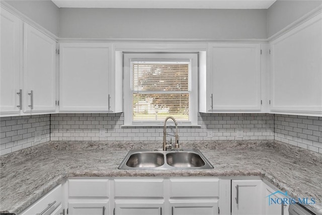 1845 Newport Ave, Toledo, OH 43613 - kitchen featuring white cabinets, light countertops, and decorative backsplash