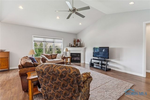 3525 Magnolia Dr, Findlay, OH 45840 - living area featuring ceiling fan, lofted ceiling, a glass covered fireplace, wood finished floors, and recessed lighting