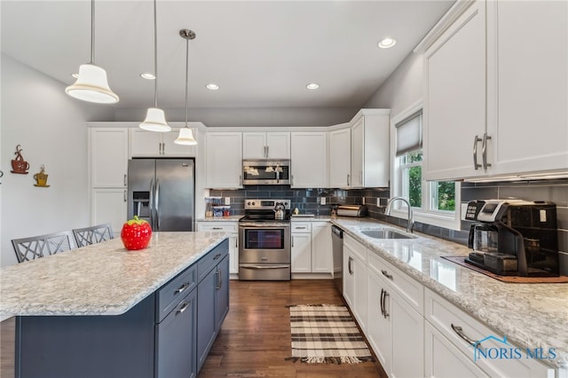 3525 Magnolia Dr, Findlay, OH 45840 - kitchen with stainless steel appliances, white cabinets, blue cabinetry, decorative backsplash, and dark wood-style floors