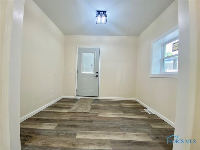 5240 Rambo Ln, Toledo, OH 43623 - doorway to outside featuring baseboards and wood finished floors