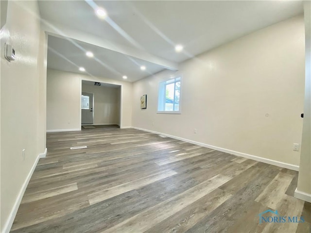 5240 Rambo Ln, Toledo, OH 43623 - unfurnished room with wood finished floors, lofted ceiling, and recessed lighting