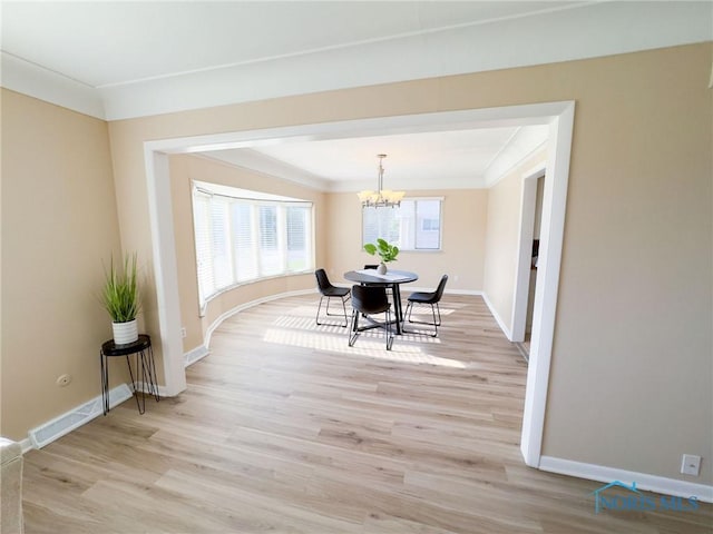 2148 Richards Rd Unit 6, Toledo, OH 43606 - dining room with crown molding, a chandelier, and light wood-style flooring