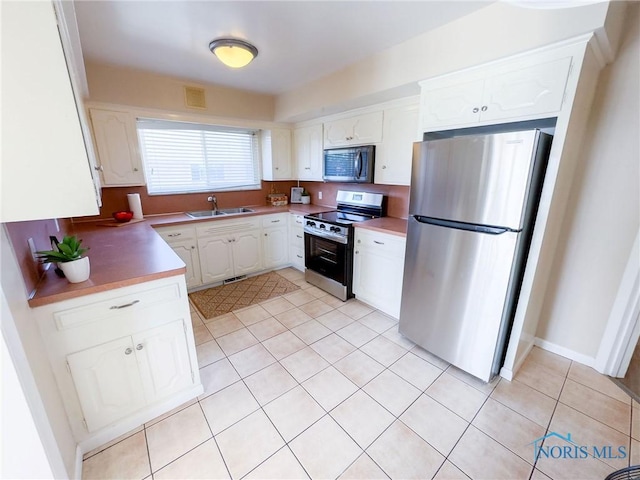 2148 Richards Rd Unit 6, Toledo, OH 43606 - kitchen with stainless steel appliances, light tile patterned flooring, white cabinetry, and light countertops