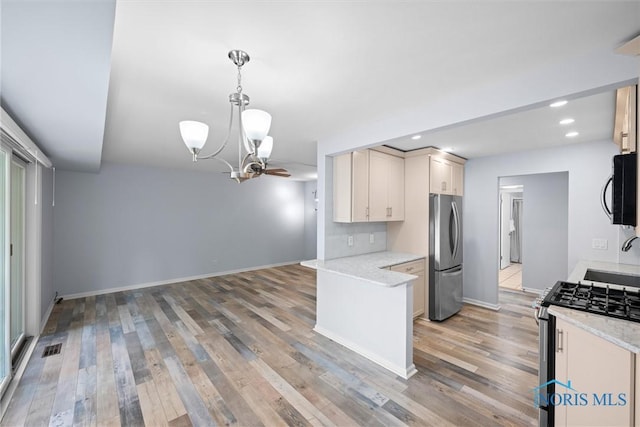 5679 Monroe St Unit 118, Sylvania, OH 43560 - kitchen with appliances with stainless steel finishes, a chandelier, light wood-type flooring, hanging light fixtures, and recessed lighting