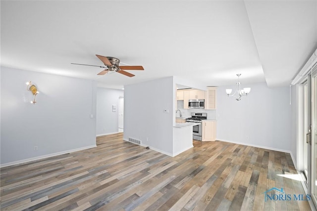 5679 Monroe St Unit 118, Sylvania, OH 43560 - unfurnished living room with a chandelier, light wood-type flooring, and a ceiling fan