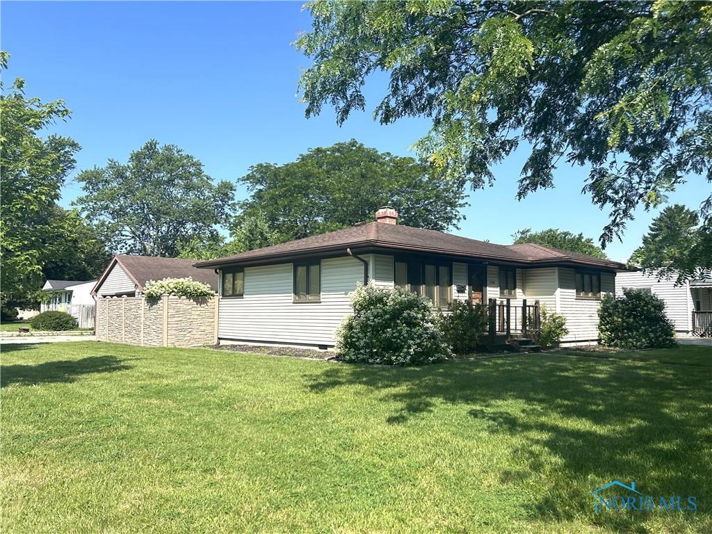 1305 Cady St, Maumee, OH 43537 - view of front facade with a front yard and a chimney