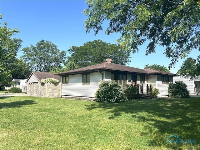 1305 Cady St, Maumee, OH 43537 - view of front facade with a front yard and a chimney