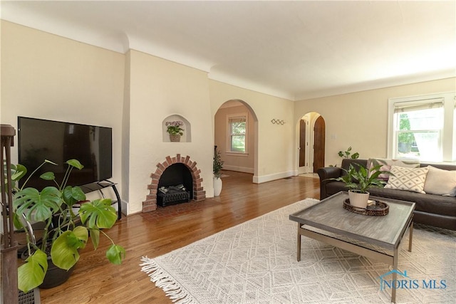 2448 Orchard Rd, Ottawa Hills, OH 43606 - living room featuring arched walkways, wood finished floors, and plenty of natural light