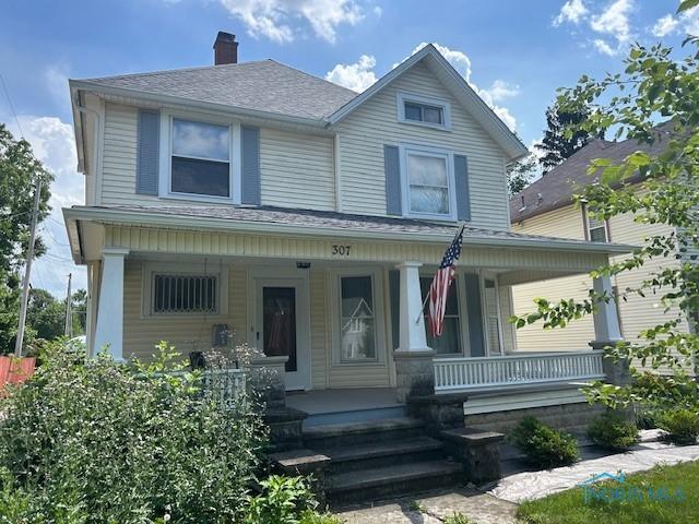 307 1st St, Findlay, OH 45840 - view of front facade featuring a porch, a chimney, and a shingled roof