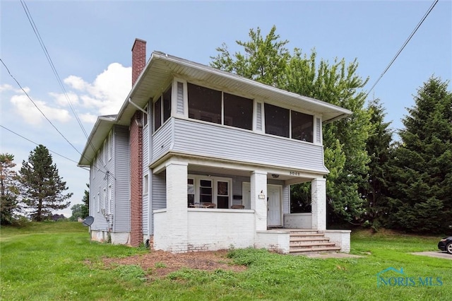 3042 Schneider Rd, Toledo, OH 43614 - view of front of home featuring a chimney, a front lawn, a sunroom, and a porch