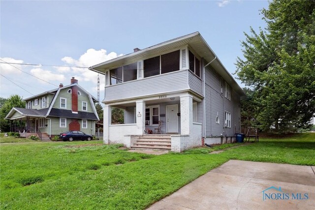 3042 Schneider Rd, Toledo, OH 43614 - view of front facade with a porch, a front lawn, and a chimney