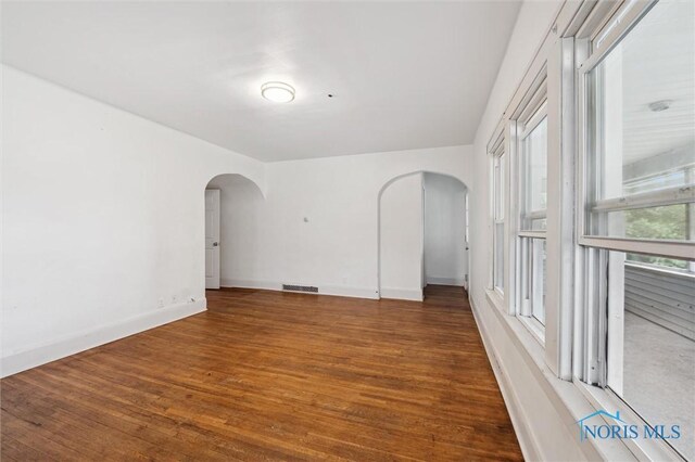 3042 Schneider Rd, Toledo, OH 43614 - empty room featuring arched walkways and wood finished floors