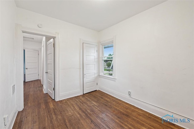 3042 Schneider Rd, Toledo, OH 43614 - unfurnished bedroom featuring dark wood-style flooring and a closet