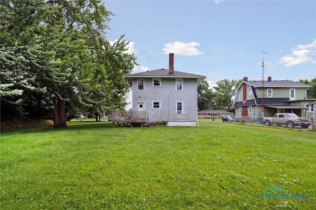 3042 Schneider Rd, Toledo, OH 43614 - rear view of house featuring a lawn and a chimney