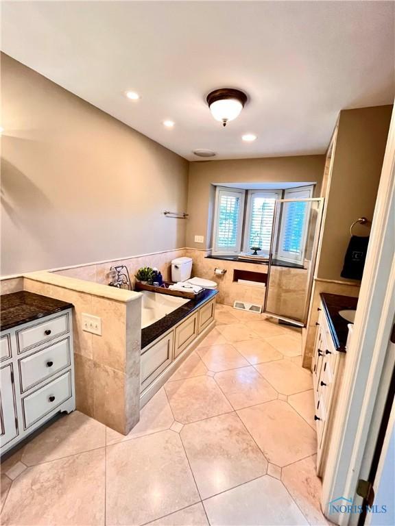 2720 Derby Rd, Ottawa Hills, OH 43615 - kitchen with tile walls, dark countertops, recessed lighting, light tile patterned floors, and wainscoting