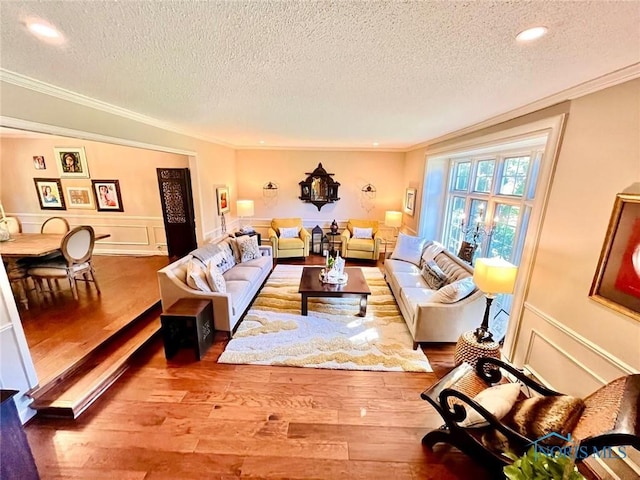 2720 Derby Rd, Ottawa Hills, OH 43615 - living area featuring a textured ceiling, crown molding, wood finished floors, recessed lighting, and a wainscoted wall