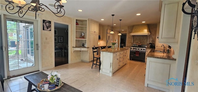2720 Derby Rd, Ottawa Hills, OH 43615 - kitchen with custom range hood, high end range, a center island, dark stone countertops, and recessed lighting