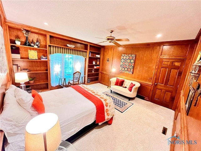 2720 Derby Rd, Ottawa Hills, OH 43615 - bedroom featuring wooden walls, a textured ceiling, carpet, and ceiling fan