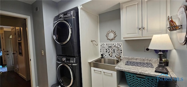 2720 Derby Rd, Ottawa Hills, OH 43615 - laundry area featuring stacked washer / drying machine and cabinet space