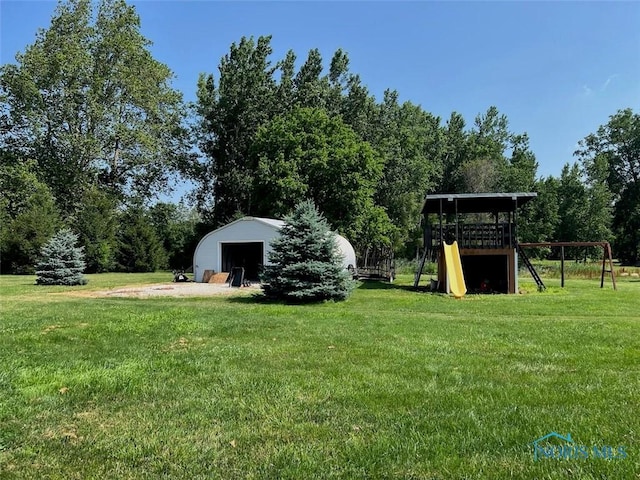 3550 Limerick Rd, Clyde, OH 43410 - view of grassy yard with a playground, a garage, and an outbuilding