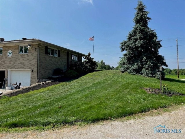3550 Limerick Rd, Clyde, OH 43410 - view of side of home with an attached garage, brick siding, and a lawn