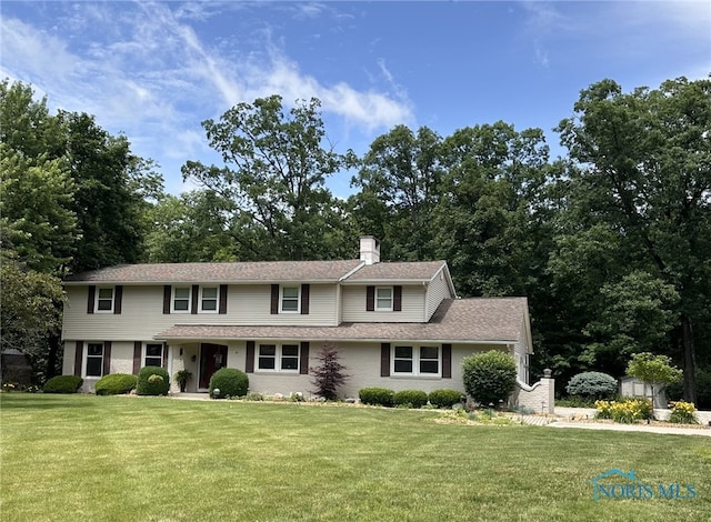 316 Northwood Dr, Defiance, OH 43512 - view of front of house featuring a front lawn, a storage shed, a chimney, and roof with shingles