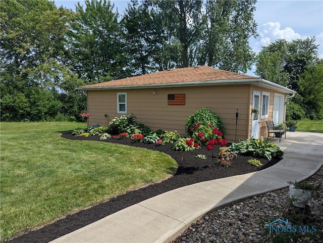 699 N Toussaint S Rd, Oak Harbor, OH 43449 - view of side of property featuring a lawn and a patio area