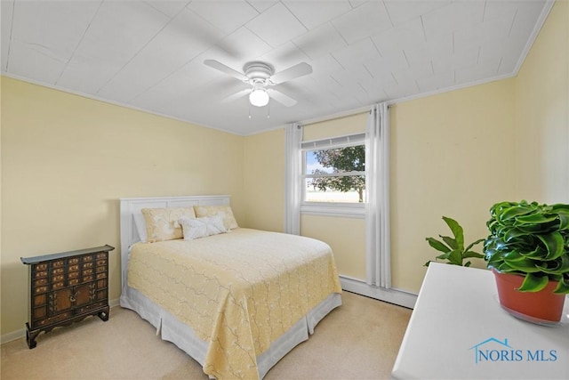 699 N Toussaint S Rd, Oak Harbor, OH 43449 - bedroom with a baseboard radiator, light carpet, a ceiling fan, and crown molding