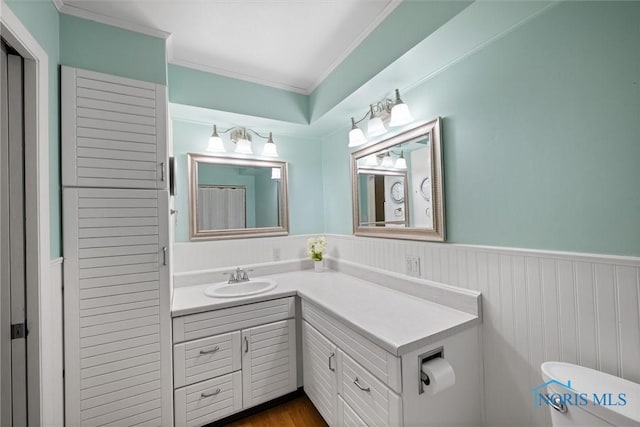 699 N Toussaint S Rd, Oak Harbor, OH 43449 - bathroom featuring vanity, a wainscoted wall, and crown molding